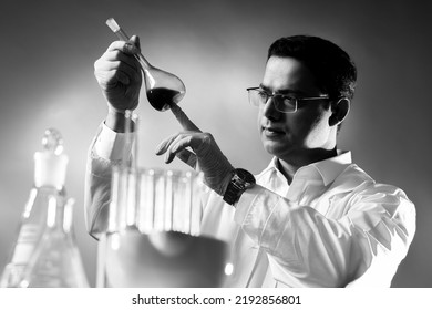 Portrait Biologist With Test Tube. Guy Looks On Tube. Young Scientist Biologist. Biologist Student Is Engaged. Bio Laboratory Employee. Indian Male Microbiologist. Black And White Effect