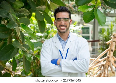 Portrait Of A Biologist In Uniform In A Greenhouse