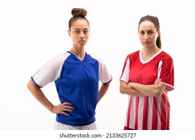 Portrait Of Biracial And Caucasian Young Female Players Standing With Arms Crossed And Hands On Hip. White Background, Unaltered, Sport, Sports Uniform, Competition, Rivalry And Women's Soccer.