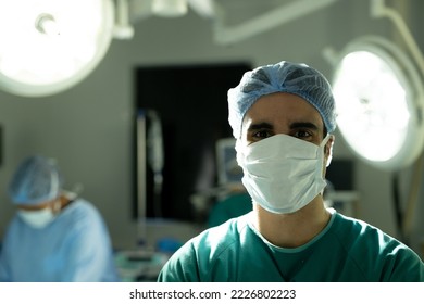 Portrait of biracial male surgeon in surgical cap and mask in operating theatre with copy space. Hospital, medical and healthcare services. - Powered by Shutterstock