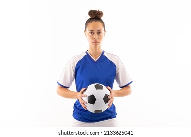 Portrait of biracial young female player holding soccer ball while standing against white background. unaltered, sport, sports uniform, copy space, athlete and women's soccer. - Powered by Shutterstock