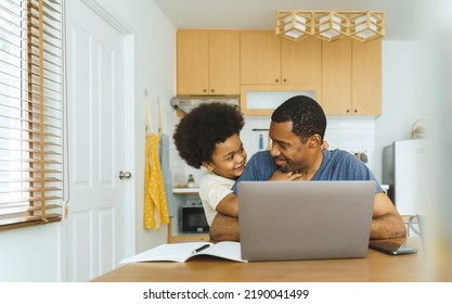 Portrait Of Black African American Father With His Little Son In The Kitchen, Happy Single Dad Playing With His Boy While Working At Home On Laptop, Freelance, Fatherhood Concept