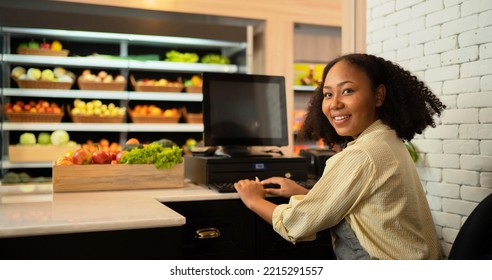 Portrait Of A Black African American Woman Working On Cashier In A Supermarket Or Retail Shop And Food On Grocery Products. Food Shopping. People Lifestyle. Checkout Business Counter Service. Worker