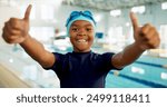 Portrait, black boy and smile with thumbs up at swimming center for training, workout and practice for child development. Male person, agree and happy or confident for sports challenge and tournament