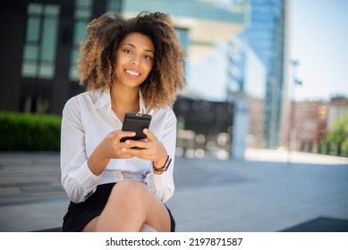 Portrait Of A Black Business Woman Using Her Mobile Phone In A Business Environment