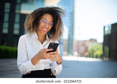 Portrait Of A Black Business Woman Using Her Mobile Phone In A Business Environment