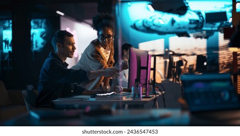 Portrait of Black Creative Director Giving Instructions on 3D Game Visuals to Male Developer in Creative Agency. Two Stylish Diverse Employees Discussing Design on Computer in Game Development Company - Powered by Shutterstock