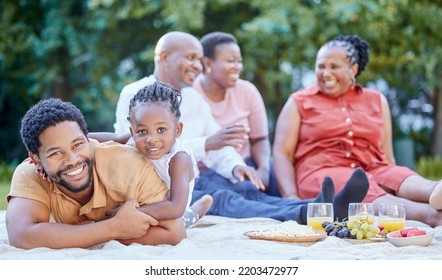 Portrait Of A Black Father And Child At A Picnic With Family In An Outdoor Green Garden During Spring. Smile, Happy And African People Eating Healthy Fruit At A Outside Celebration In A Park.