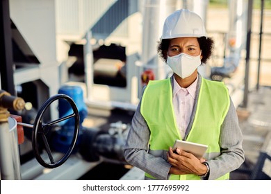 Portrait Of Black Female Architect Wearing Protective Face Mask At Industrial Construction Site. 