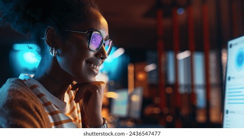 Portrait of Black Female Working in Creative Agency, Implementing Modern Business Strategy for Clients. Successful Specialist Using Desktop Computer with Green Screen Mock Up Display - Powered by Shutterstock