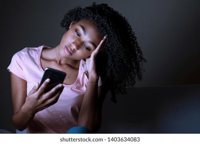 Portrait Of Black Girl Holding Phone At Night