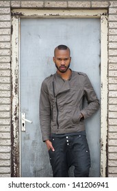 Portrait of a black male model posing in a door frame - Shutterstock ID 141206941