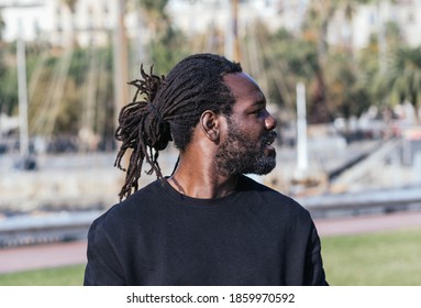 Portrait Of A Black Man With Dreadlocks In A Park