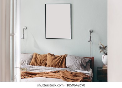 Portrait Black Picture Frame Mockup On Sage Green Wall. Bedroom View Through Open White  Door. Grey Linen And Rusty Muslin Pillows On Wooden Bed. Scandinavian Interior. Ceramic Vase With Dry Grass. 