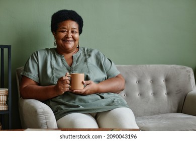 Portrait Of Black Senior Woman Smiling At Camera While Enjoying Cup Of Coffee At Home, Copy Space