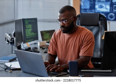 Portrait of black software engineer using computer in high technology office, data systems and programming concept, copy space - Powered by Shutterstock