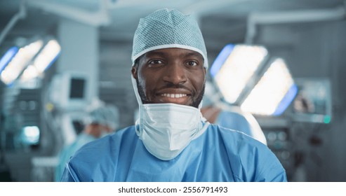 Portrait of Black Surgeon Taking off His Surgical Mask After a Successful Operation. Healthcare Professional Posing, Looking at Camera and Smiling. Photo in a Modern Hospital Operating Room - Powered by Shutterstock