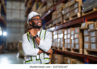 A Portrait Of A Black Warehouse Manager Standing With A Barcode Reader In A Large Distribution Center