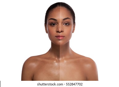 Portrait Of A Black Woman With A Half Of A Face With A Whitening Skin Over White Background