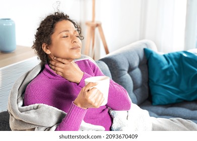 Portrait Of Black Woman Suffering Sore Throat At Home