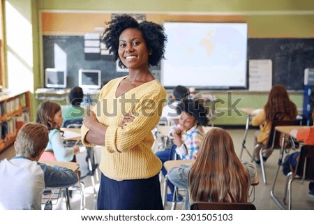 Portrait, black woman and teacher with arms crossed, students or happiness in a classroom. Face, female educator or employee with children, smile or education with knowledge, learners and development