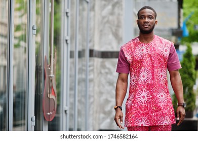 Portrait Of A Black Young Man Wearing African Traditional Red Colorful Clothes.