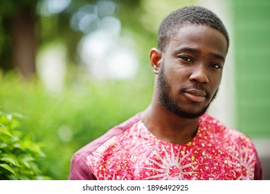 Portrait Of A Black Young Man Wearing African Traditional Red Colorful Clothes.