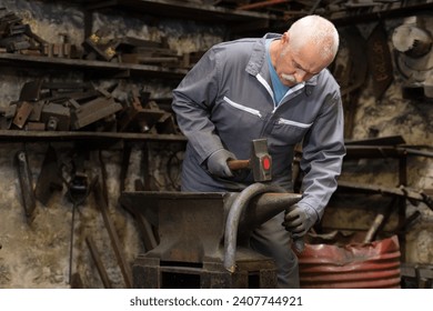 portrait of blacksmith in his workshop - Powered by Shutterstock