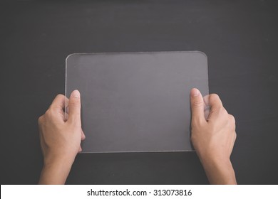 A portrait of a blank glass square on black background, futuristic transparent tablet mock up - Powered by Shutterstock