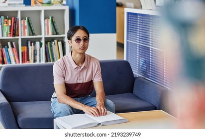 Portrait Of Blind Asian Man Reading Book In Tactile Braille And Wearing Sunglasses, Copy Space