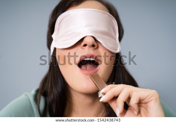 Portrait Of\
Blindfolded Young Woman Testing\
Food