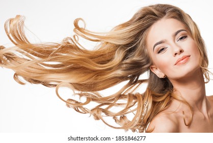 Portrait of blond beauty with amazing long healthy hair.