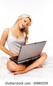 Portrait Of Blond Sexy Woman Laying In Bed With Laptop Computer