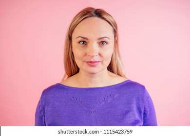 Portrait Of A Blond Woman 30-35 Years Old On A Pink Background In The Studio