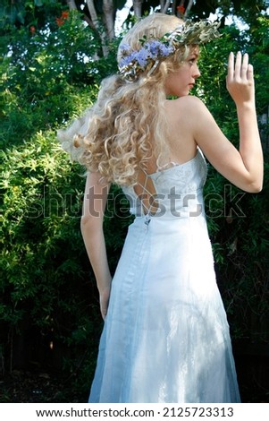 portrait of blonde fairytale maiden wearing beautiful gown