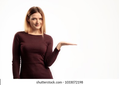 portrait of blonde girl wearing simple. standing, isolated on studio background.