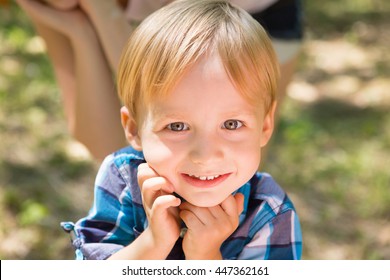 Portrait of blonde little boy posing outside
 - Powered by Shutterstock