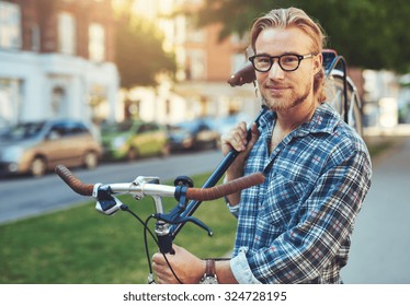 Portrait of blonde white man in the city with a bike - Powered by Shutterstock