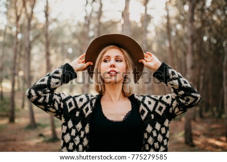 Image, Stock Photo Blonde woman portrait with the hands in her hat, discovering the forest.