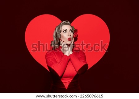 Portrait of a blonde woman with 50's characteristic hair, make-up, and clothes. A romantic concept with a retro-style woman isolated on a red background, with a heart-shaped light on her.