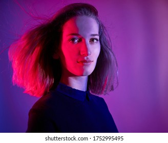 Portrait Of A Blonde Woman With Colored Lights In The Studio.