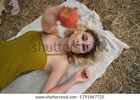 Portrait of blonde woman having a picnic in the park