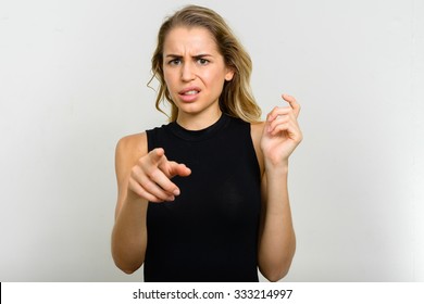 Portrait of blonde woman looking disgusted - Shutterstock ID 333214997