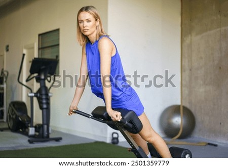 Woman looking at camera while doing reverse sit-ups