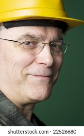 Portrait Of A Blue Collar Senior Workman Wearing A Yellow Hardhat