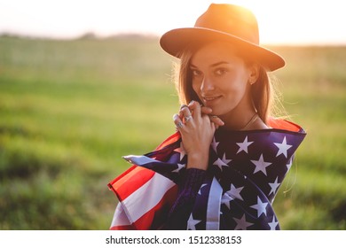 Portrait Of Boho Chic Woman In Hat With American Flag Wearing Silver Rings With Turquoise Stone At Sunset. Jewelry Indie Girl With Hippie Style And Boho Fashion. Travel To America