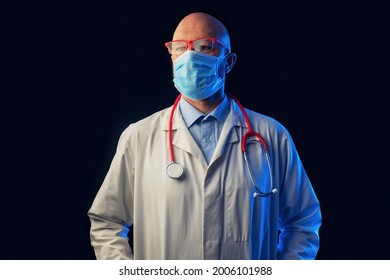 Portrait of a bold male doctor on a dark background. Man in his 40s, in white uniform red glasses and stethoscope. Teal and blue color.