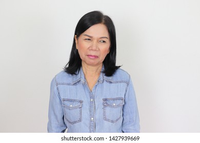 Portrait Of Bored Old Asian Woman Standing And Feeling Unhappy On White Background