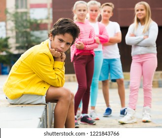 Portrait Of Boy 9-12 Years Old Who Is Taking Offense On His Friends In The Park.