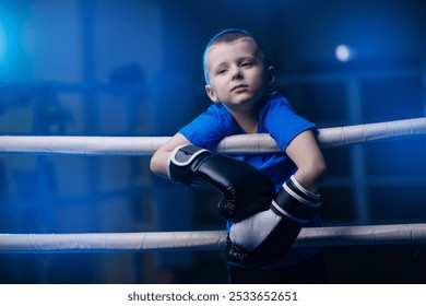 Portrait boy in black boxing gloves is training in ring, sport kid boxer tired in gym - Powered by Shutterstock